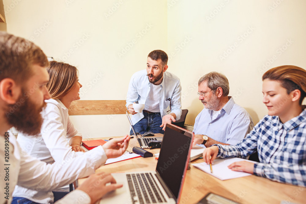 Team job. Photo young businessmans working with new project in office Team job. Photo young businessmans working with new project in office