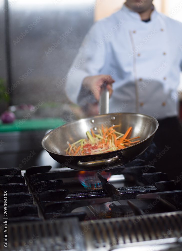 Chef doing flambe on food Chef doing flambe on food