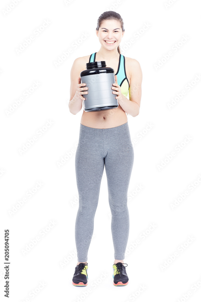 Portrait of slim female athlete holding container with sports nutrition isolated on white Portrait of slim female athlete holding container with sports nutrition isolated on white