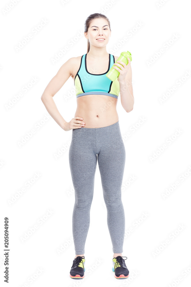 Portrait of slim girl in sports clothes holding water bottle on white background Portrait of slim girl in sports clothes holding water bottle on white background