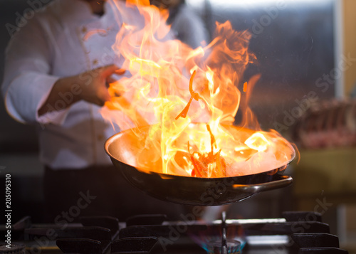 Chef doing flambe on food