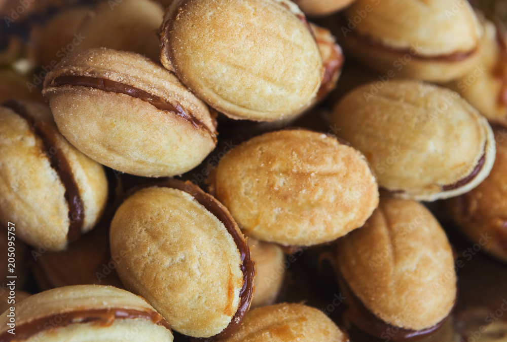Cookies in shape of nut with condensed milk, closeup Cookies in shape of nut with condensed milk, closeup