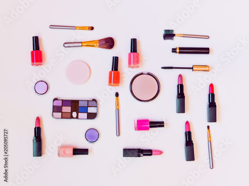 Makeup cosmetics and brushes on pastel background