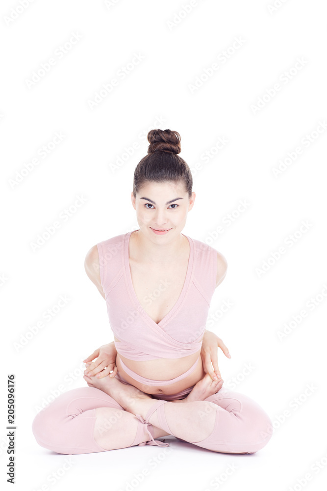 Young woman, professional yoga instructor practicing asanas isolated on white Young woman, professional yoga instructor practicing asanas isolated on white