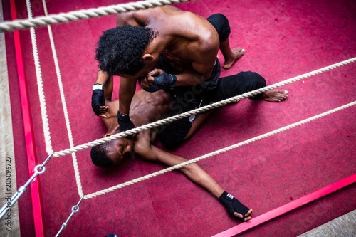 Fotografie High angle view of African American fighter punching his opponent in the face du