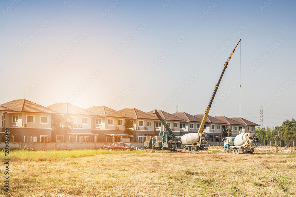 House building at construction site with crane truck