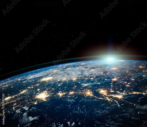 Fototapeta Naklejka Na Ścianę i Meble -  Beautiful Earth space view by night with sun on horizon with copyspace. Science background. Elements of this photo furnished by NASA.