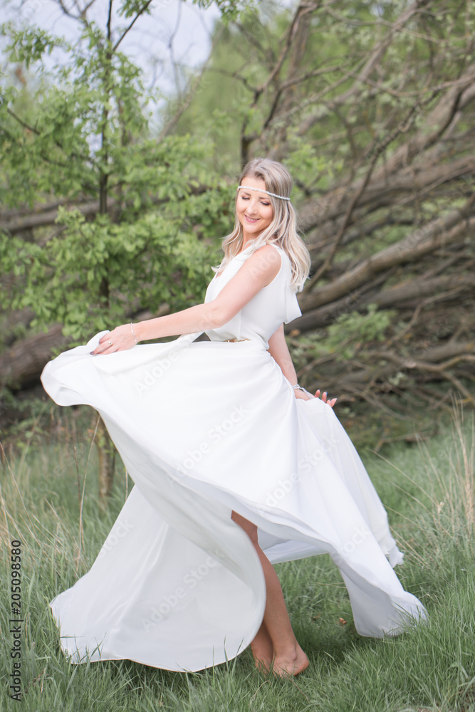 Beautiful woman - the bride. Boho style woman. Barefoot beautiful woman on the clearing. Natural, Nymph. Beautiful woman - the bride. Boho style woman. Barefoot beautiful woman on the clearing. Natural, Nymph.