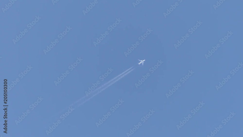 Airplane flying over head in sunny blue sky Airplane flying over head in sunny blue sky