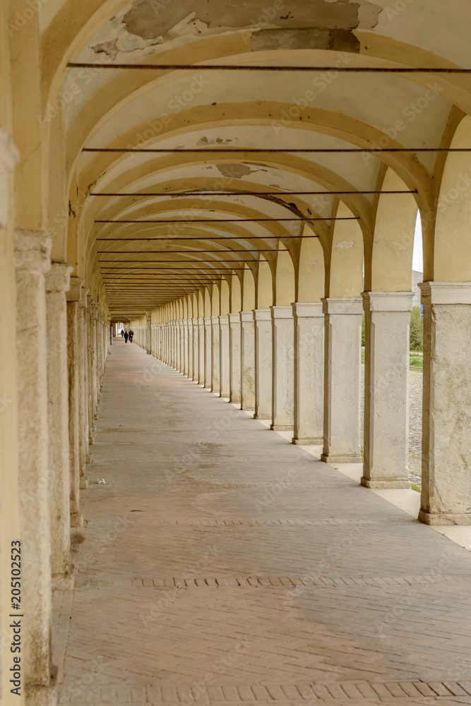 under santa Maria covered walkway on Mazzini street, Comacchio, Italy
