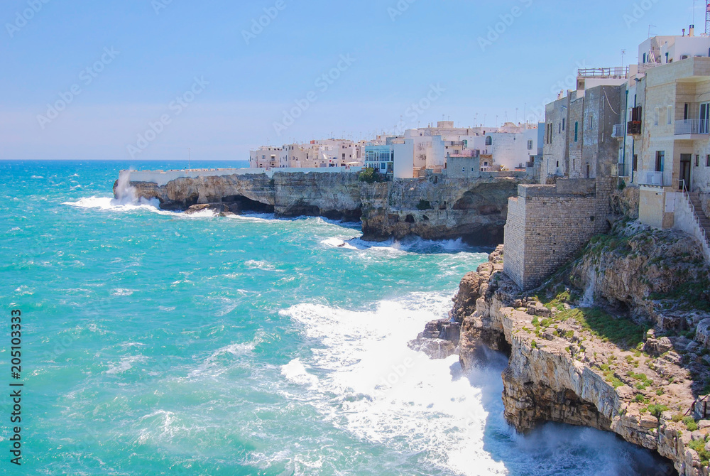 View of Polignano a Mare with rough and sea foam
