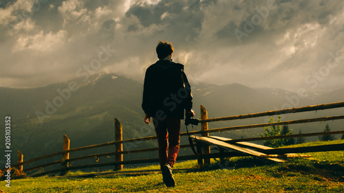 Incredible mountains. Portrait of a guy from behind. Atmospheric photography