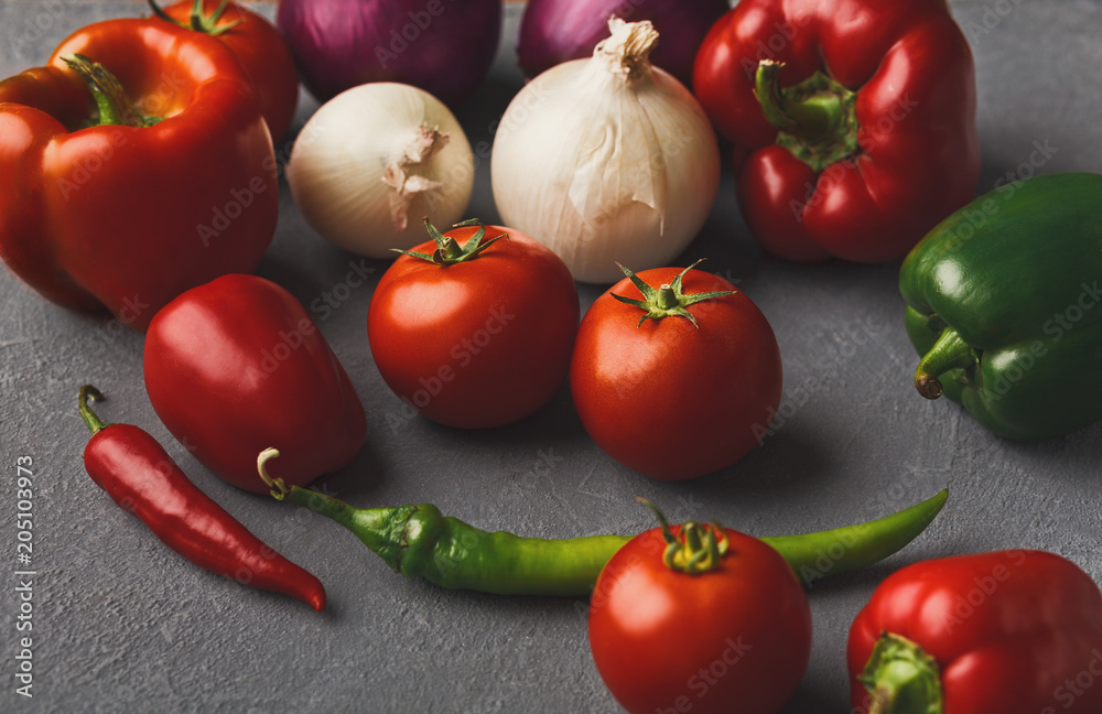 Fresh tomatoes and chilli closeup on grey rustic wood Fresh tomatoes and chilli closeup on grey rustic wood