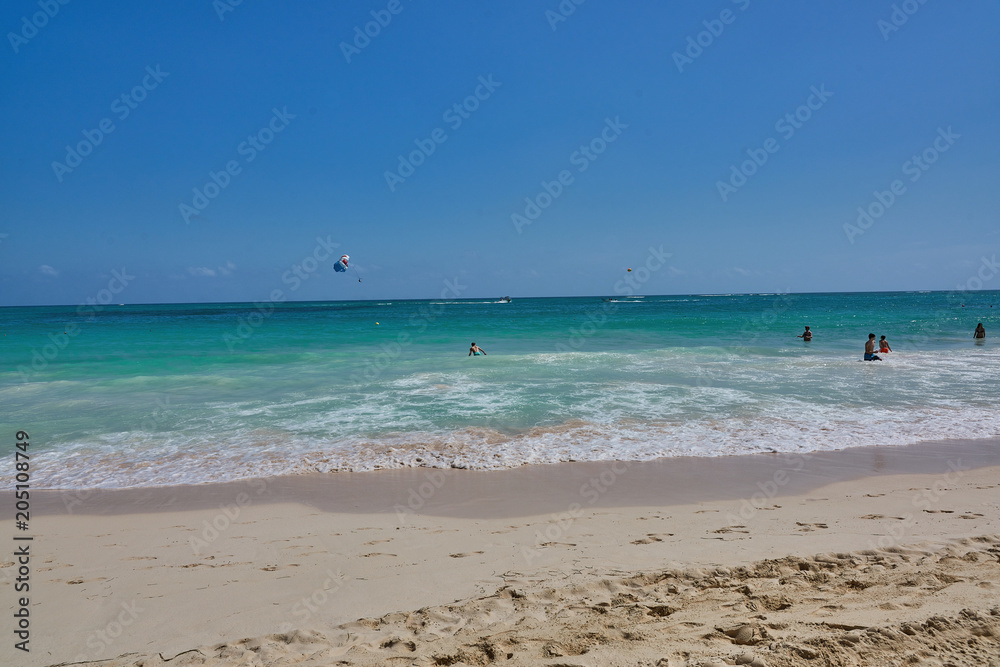 Typical summer at the beach action with parasailing in the background no identifyable faces, names or trademarks