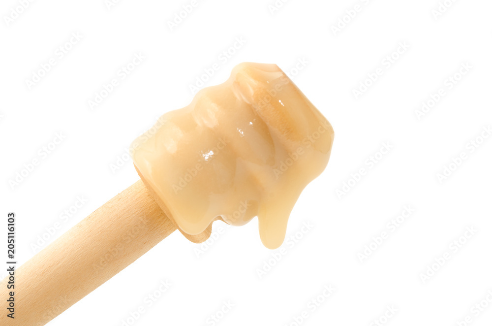 Honig tropfend vom Honiglöffel Honig tropfend vom Honiglöffel