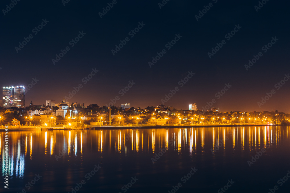 Reflection of night city lights in water or river