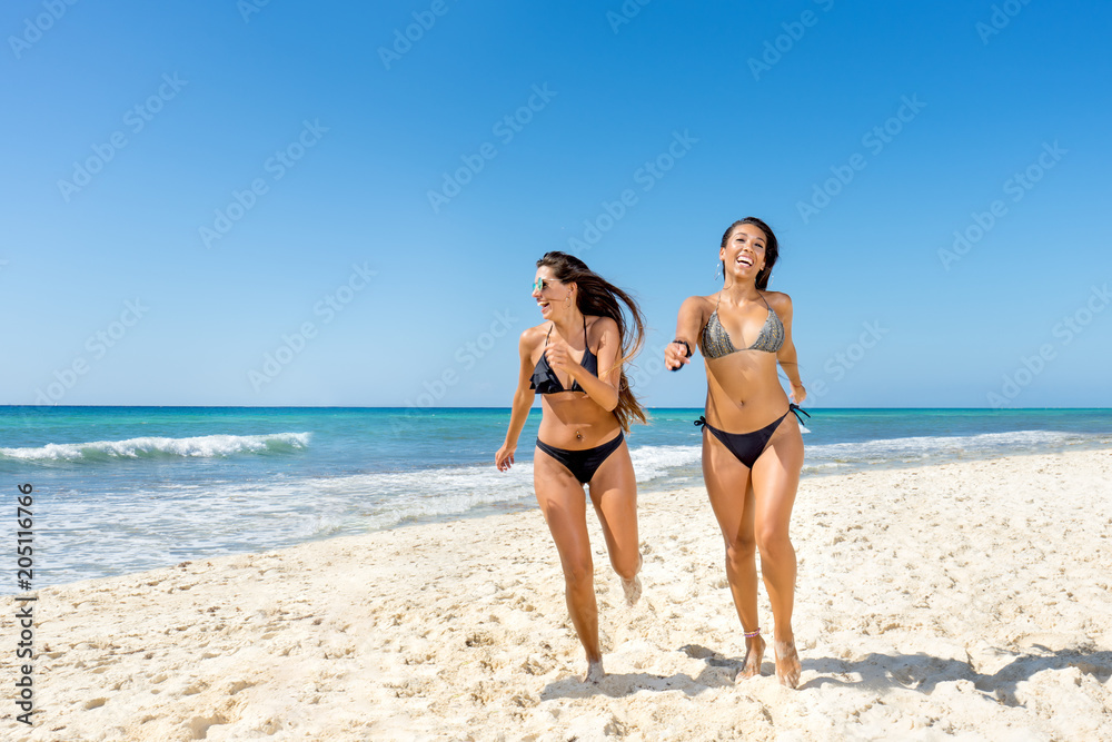 Young women running at the beach