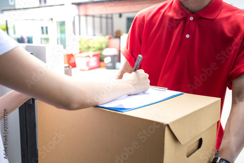 Woman receive Box from  Delivery Man and Sign on Smartphone. People with Delivery Concept.