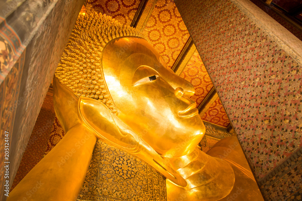 Reclining Buddha gold statue in Thai temple