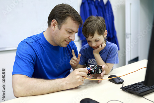 Father with son programming robot