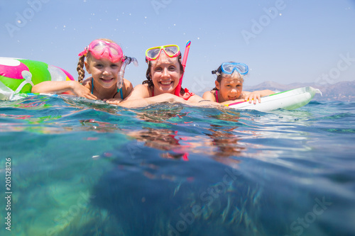 family swimming in the sea