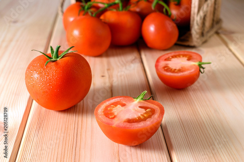 Close-up of fresh, ripe tomatoes on wooden background.
