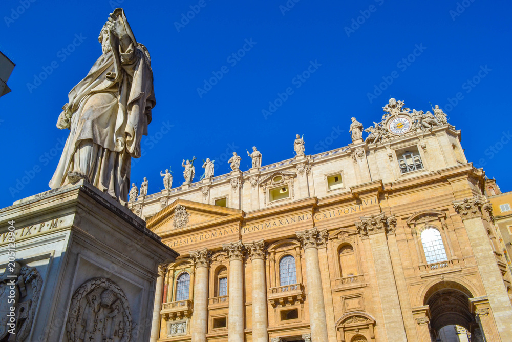 View of the Statue of Saint Paul The Apostle and St. Peter's Basilica at background from St. Peter's Square (Piazza San Pietro) in the Vatican City. Rome, Italy