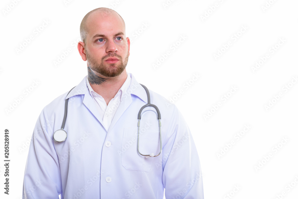 Studio shot of young bald muscular man doctor Studio shot of young bald muscular man doctor