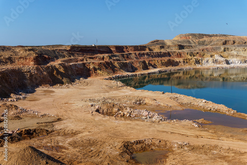 Top view of natural blue lakes in a sandy quarry on a Sunny day