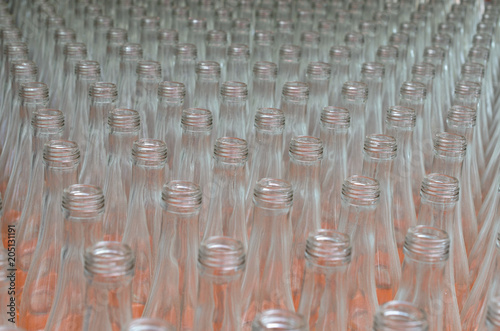 Many empty translucent bottles in a row are perspective.