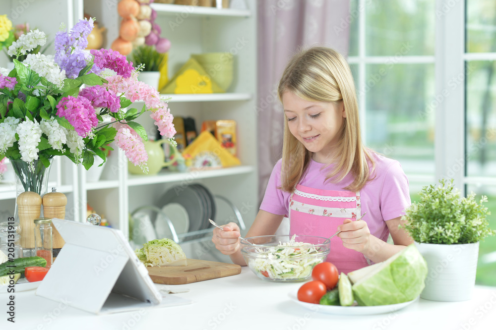 Cute little girl preparing fresh salad Cute little girl preparing fresh salad