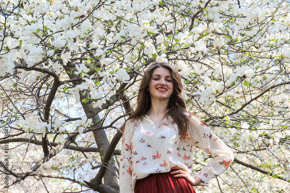 Pretty girl in beautiful magnolias tree garden Pretty girl in beautiful magnolias tree garden