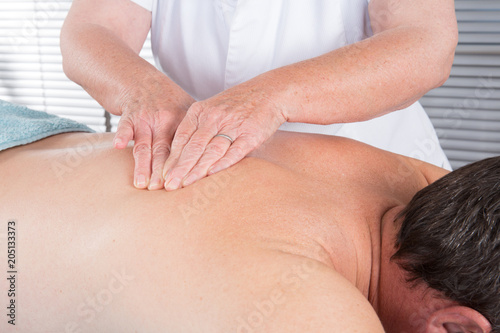 Man having a back massage in spa wellness center