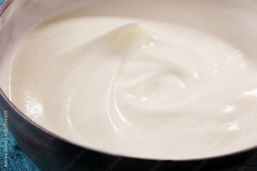 close up of a white whipped or sour cream in bowl.