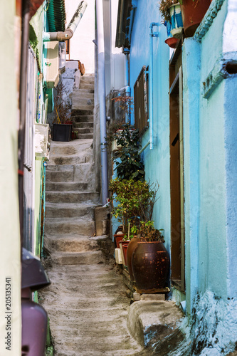 Narrow street among old bright houses with stairs © Анна Демидова