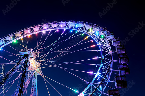 Big ferris wheel with festive colorful illumination