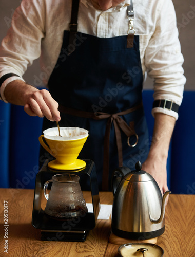 Bartender Hand drip coffee , Barista pouring water on coffee ground with paper filter