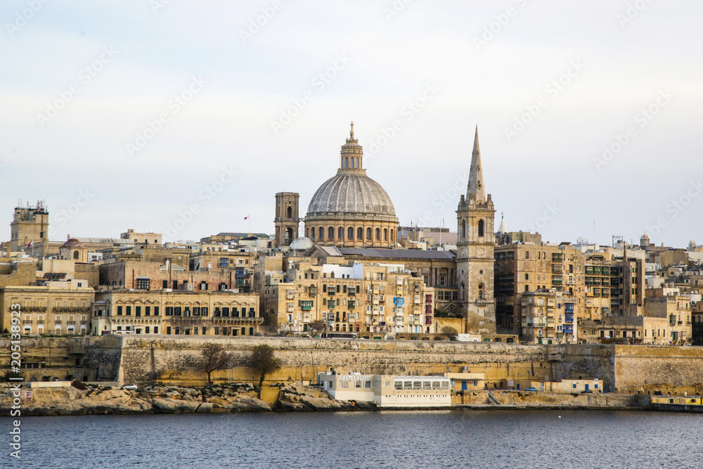 Panoramic view of Valleta, Malta at sunrise with Carmelite Church dome and St. Pauls Anglican Cathedral