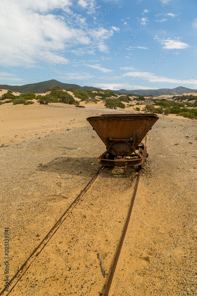 Rusty mine cart on abandoned tracks Rusty mine cart on abandoned tracks