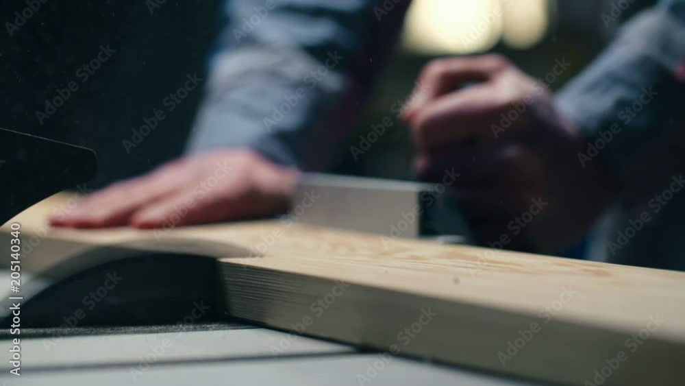 Circular saw cuts wooden beam in half Circular saw cuts wooden beam in half