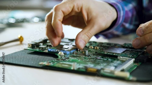 computer upgrade. technology development. microelectronics scientific innovation concept. engineer removing cpu from motherboard socket photo
