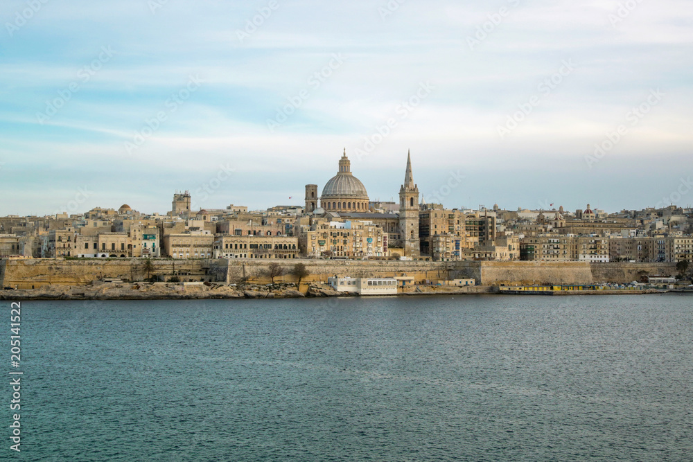 Panoramic view of Valleta, Malta at sunrise with Carmelite Church dome and St. Pauls Anglican Cathedral