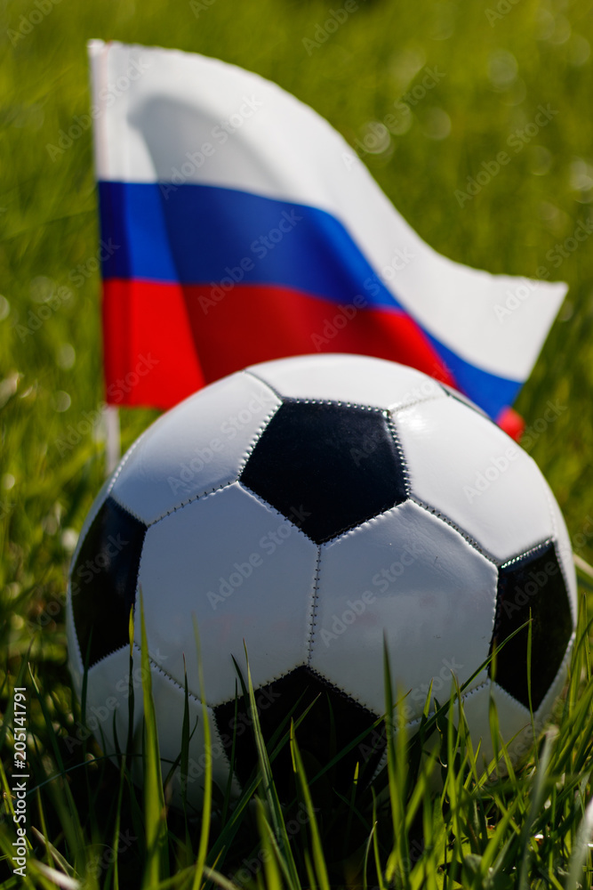 Fototapeta premium Soccer ball on the grass and the Russian flag