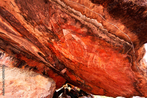 Ancient aboriginal painting art on huge rock stone in Kakadu park, northern territory, Australia. photo