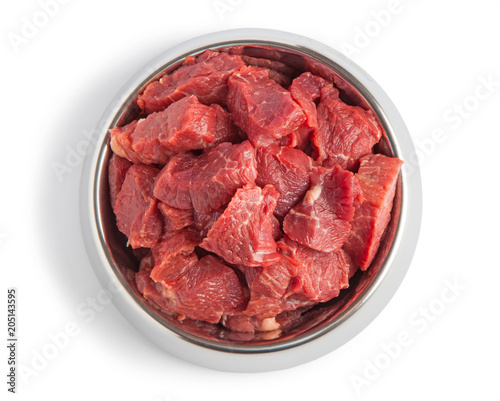 Raw beef meal in bowl, fresh, natural food for dog or cat, isolated on white background.  Top view.