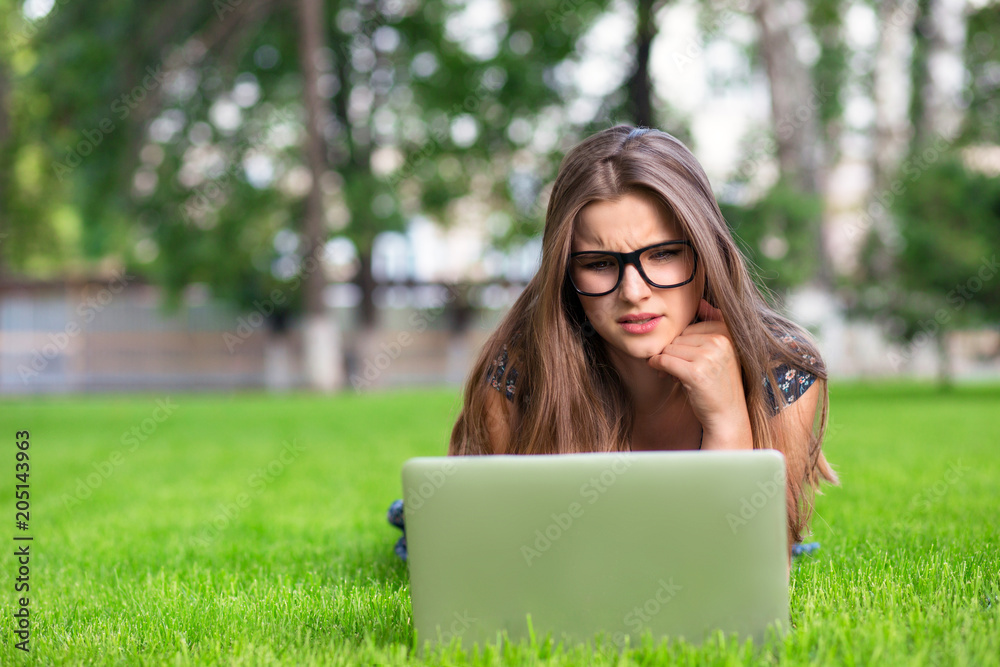woman in glasses using laptop received a bad message on pc outside woman in glasses using laptop received a bad message on pc outside