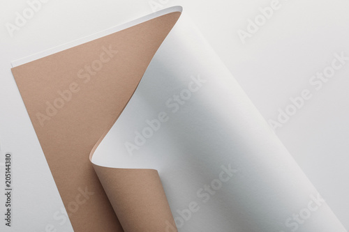 white and brown paper sheets on grey background