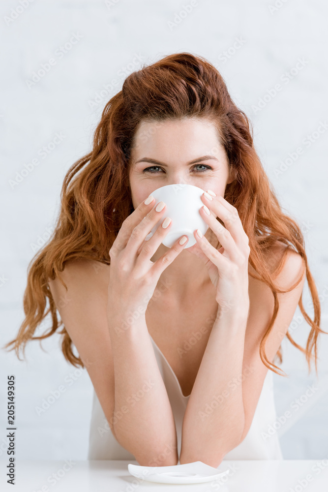 close-up portrait of beautiful young woman drinking coffee close-up portrait of beautiful young woman drinking coffee
