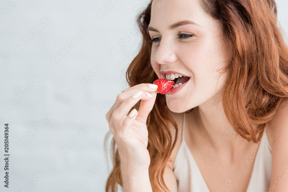 close-up portrait of beautiful young woman eating strawberry close-up portrait of beautiful young woman eating strawberry