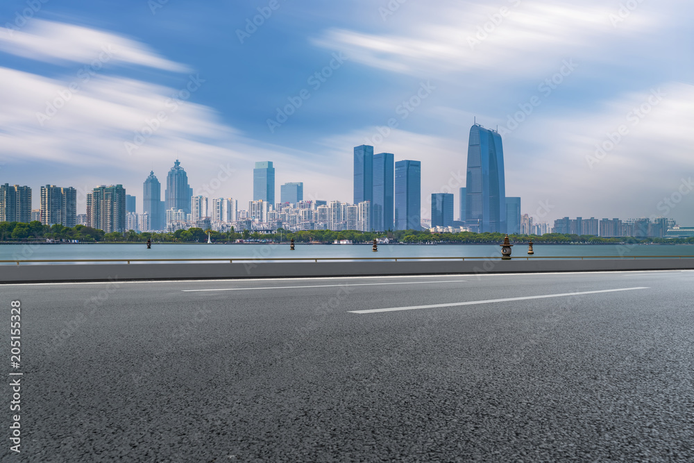 The empty asphalt road is built along modern commercial buildings in China's cities. The empty asphalt road is built along modern commercial buildings in China's cities.